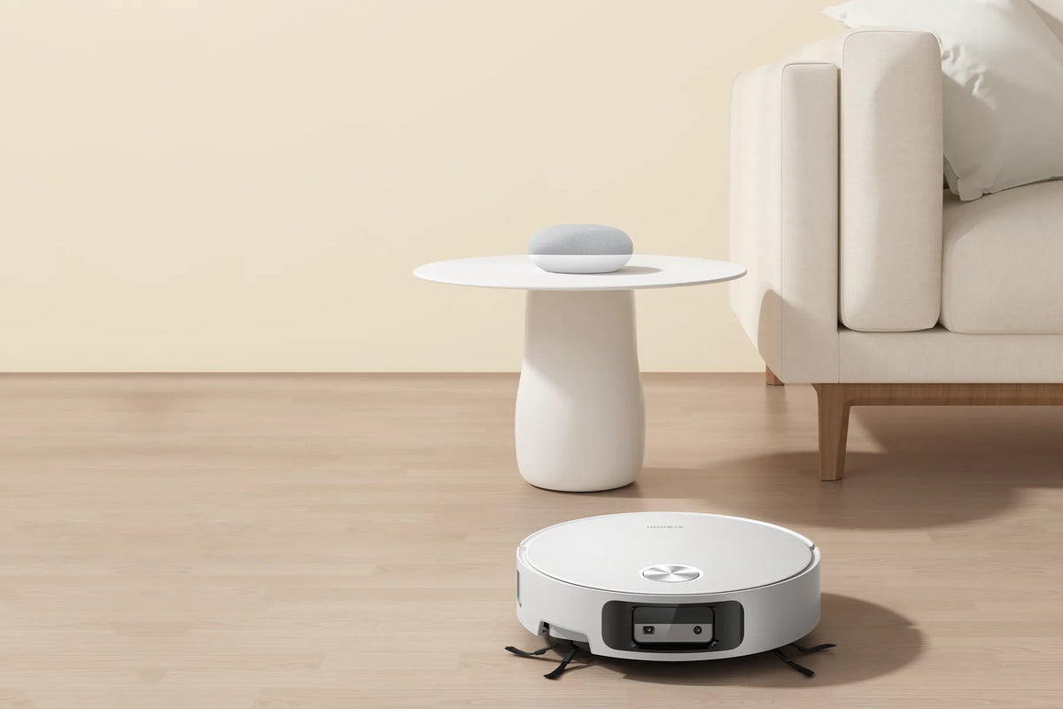 Xiaomi Robot Vacuum 6 in een lichte woonkamer, naast de bank en een bijzettafel
