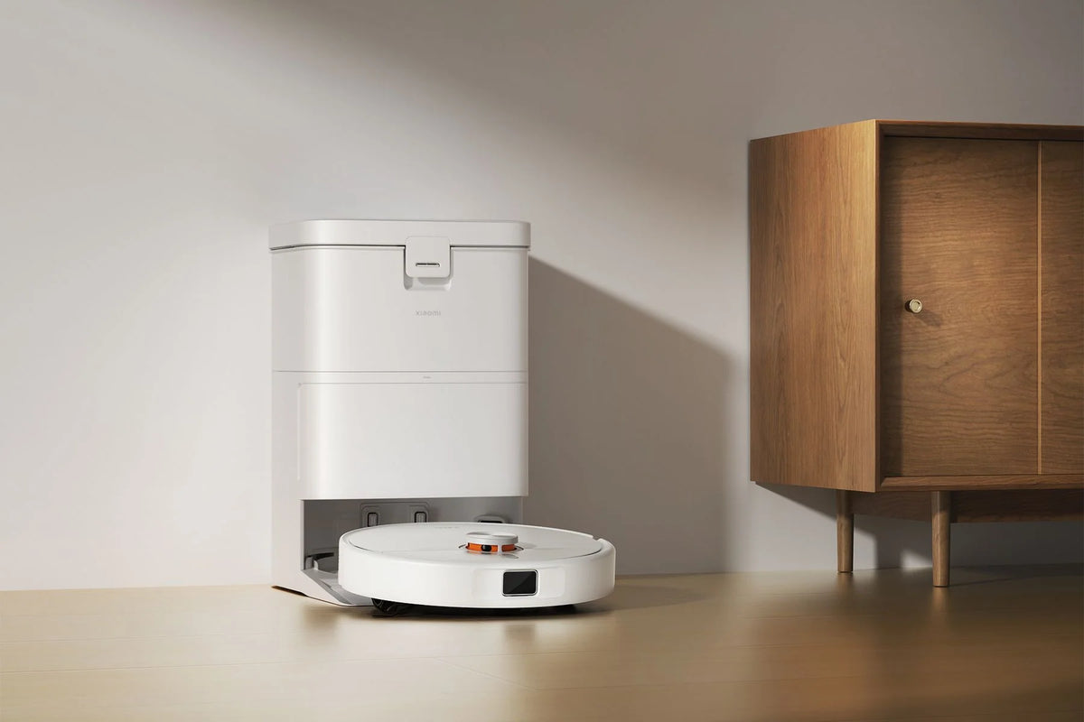 Xiaomi Robot Vacuum H50 met station naast een houten kast
